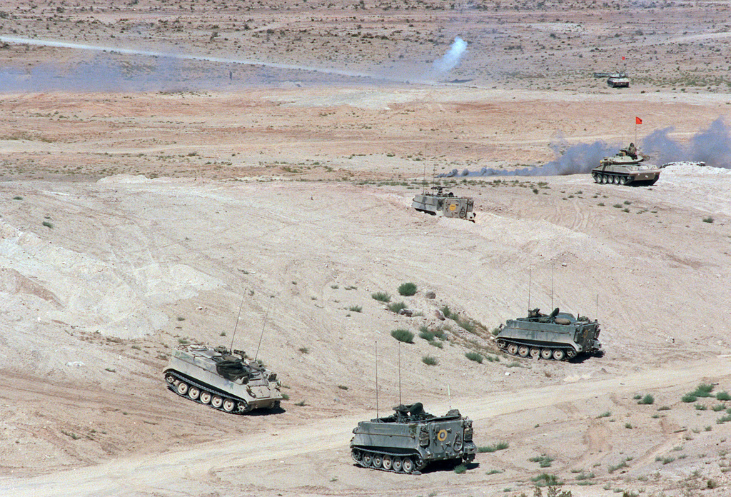 m113-armored-personnel-carriers-gather-on-a-desert-hill-side-as-tanks-enter-94b066-1024.jpg