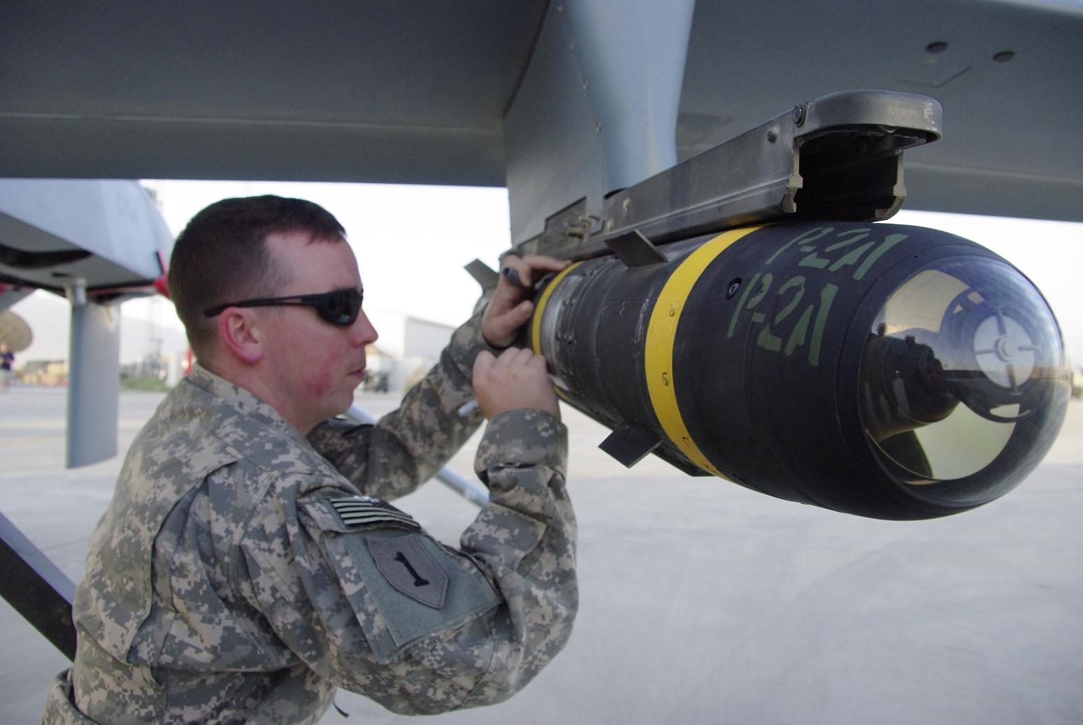 signing-a-hellfire-missile-attached-to-a-mq1-c-gray-eagle-uav-at-bagram.jpg
