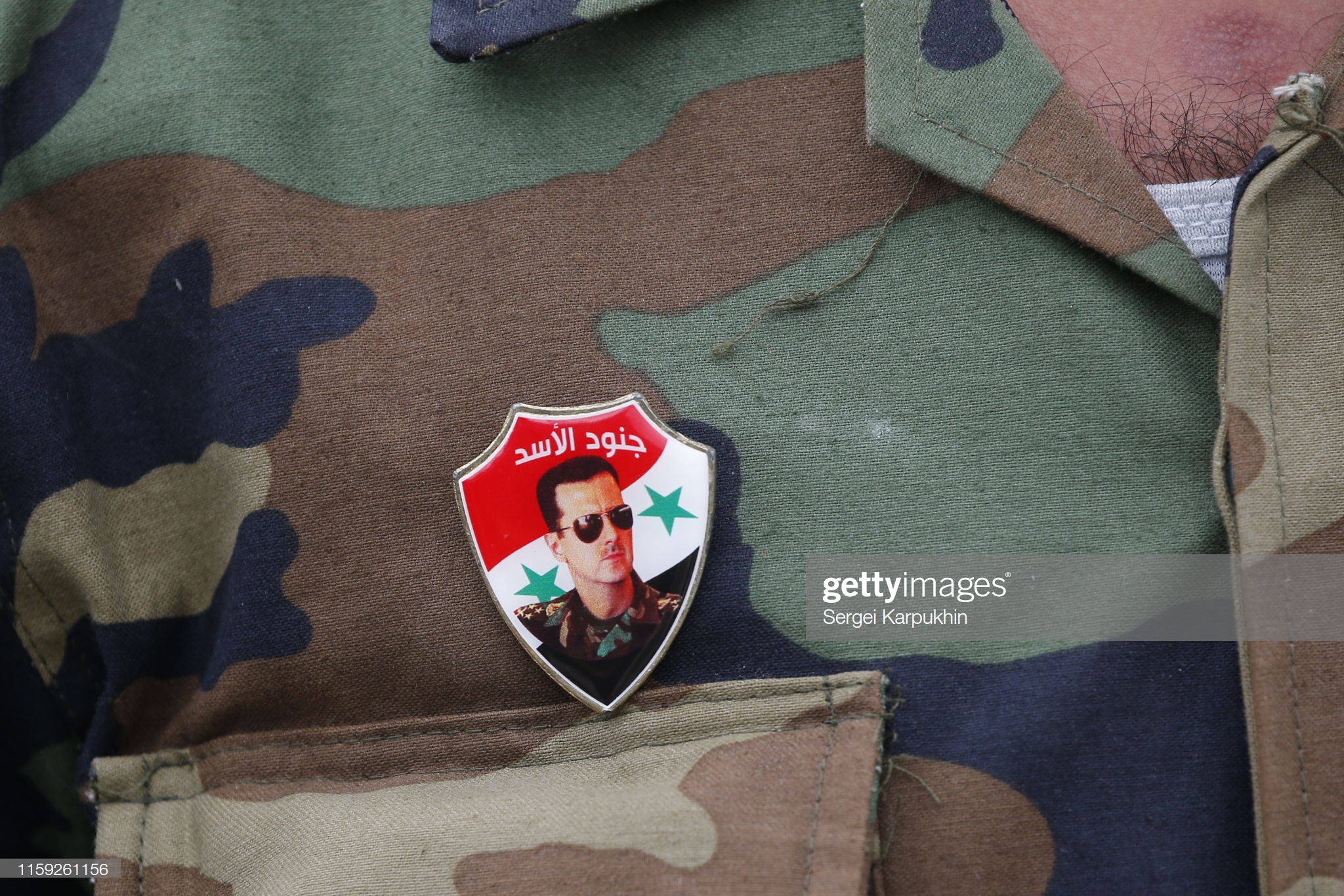 servicemans-badge-featuring-bashar-alassad-seen-at-the-opening-of-the-picture-id1159261156