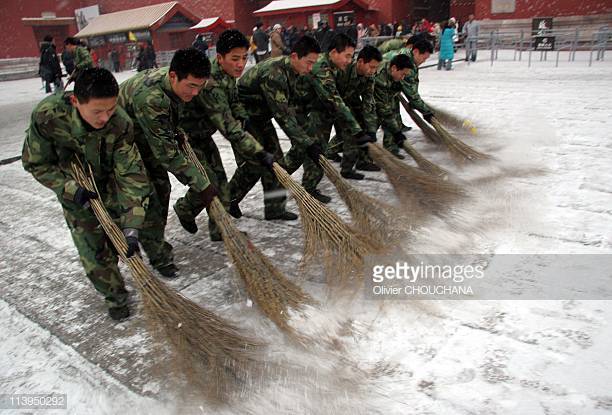 snow-in-beijing-china-on-january-18-2008army-recruits-help-sweep-away-picture-id113950292