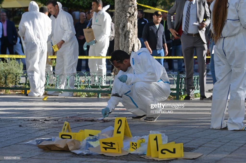 tunisian-forensics-inspect-the-site-of-a-suicide-attack-in-the-on-picture-id1055016814