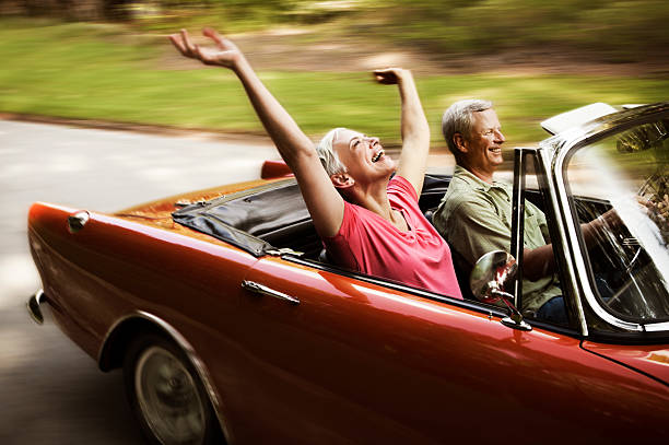 happy-senior-couple-going-for-a-drive-picture-id108329737