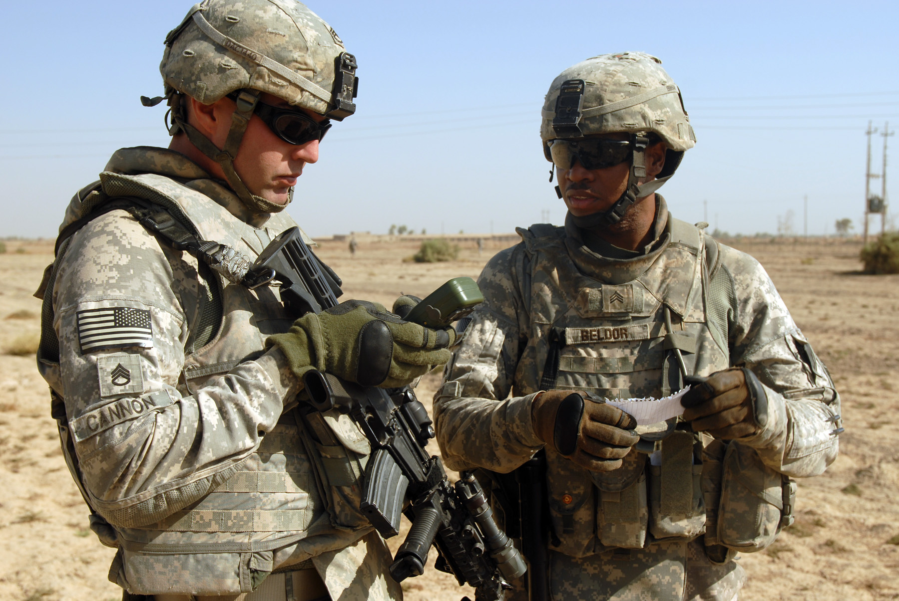 US_Army_52935_TAJI,_Iraq_-_Staff_Sgt._William_Cannon_(left),_of_Taylor,_Mich.,_and_Sgt._Jhonny_Beldor,_of_Fredericksburg,_Pa.,_confer_about_directions_during_a_patrol_near_Taji_Oct._5._Both_non-commissioned_officer.jpg