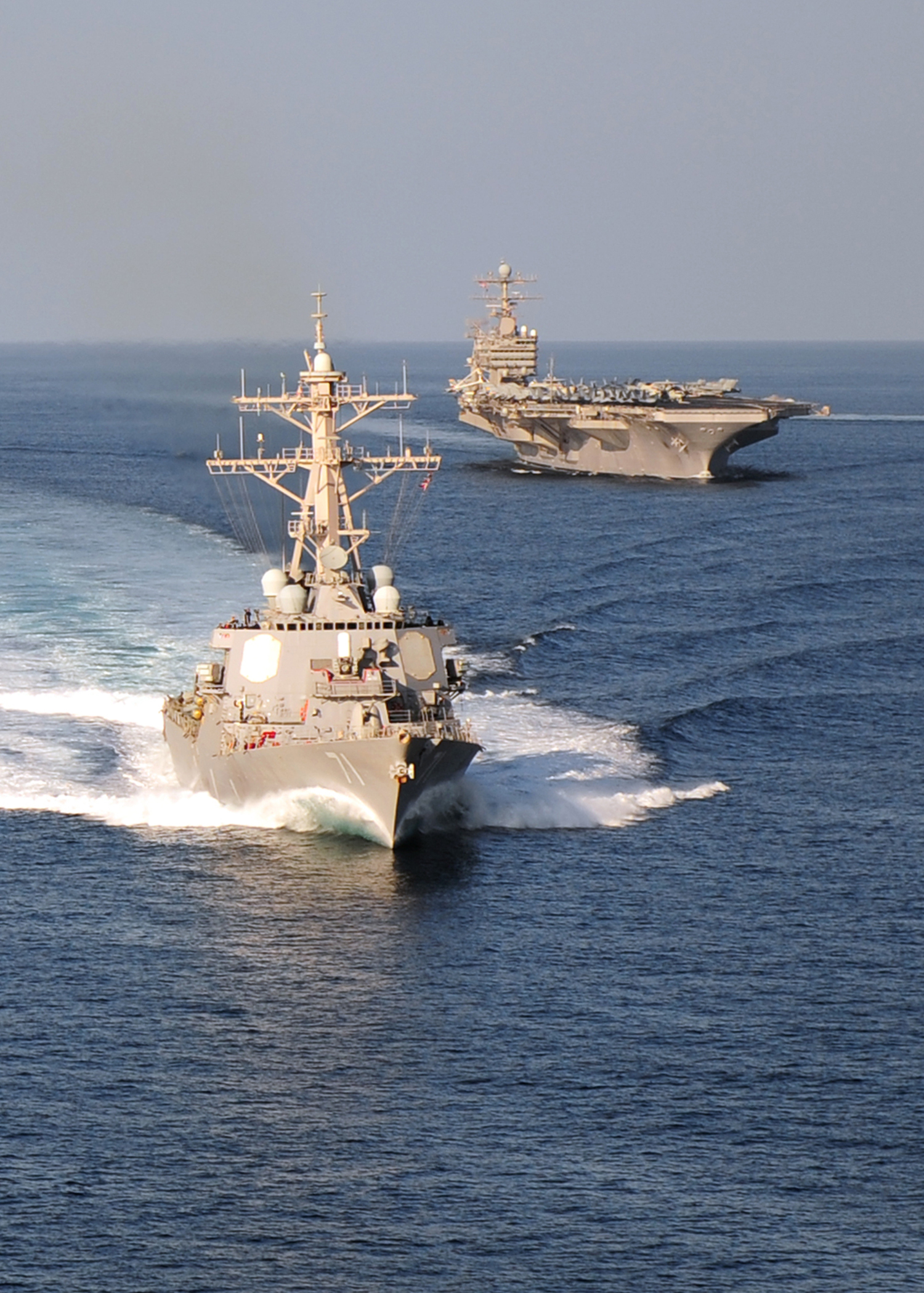 US_Navy_101123-N-4856N-492_The_guided-missile_destroyer_USS_Ross_(DDG_71)_and_the_aircraft_carrier_USS_Abraham_Lincoln_(CVN_72)_cruise_in_a_formati.jpg