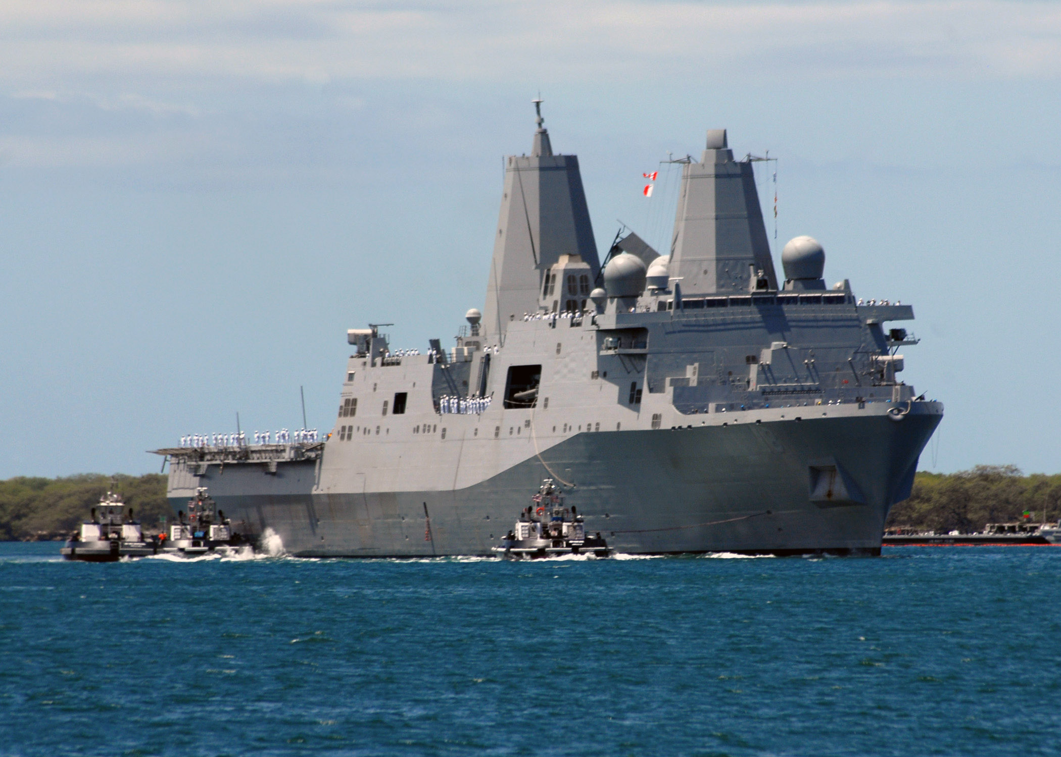 US_Navy_070911-N-9758L-088_Tugboats_assigned_to_Naval_Station_Pearl_Harbor_assist_San_Antonio-class_amphibious_transport_dock_USS_New_Orleans_%28LPD_18%29_to_the_pier_at_Fleet_and_Industrial_Supply_Center.jpg