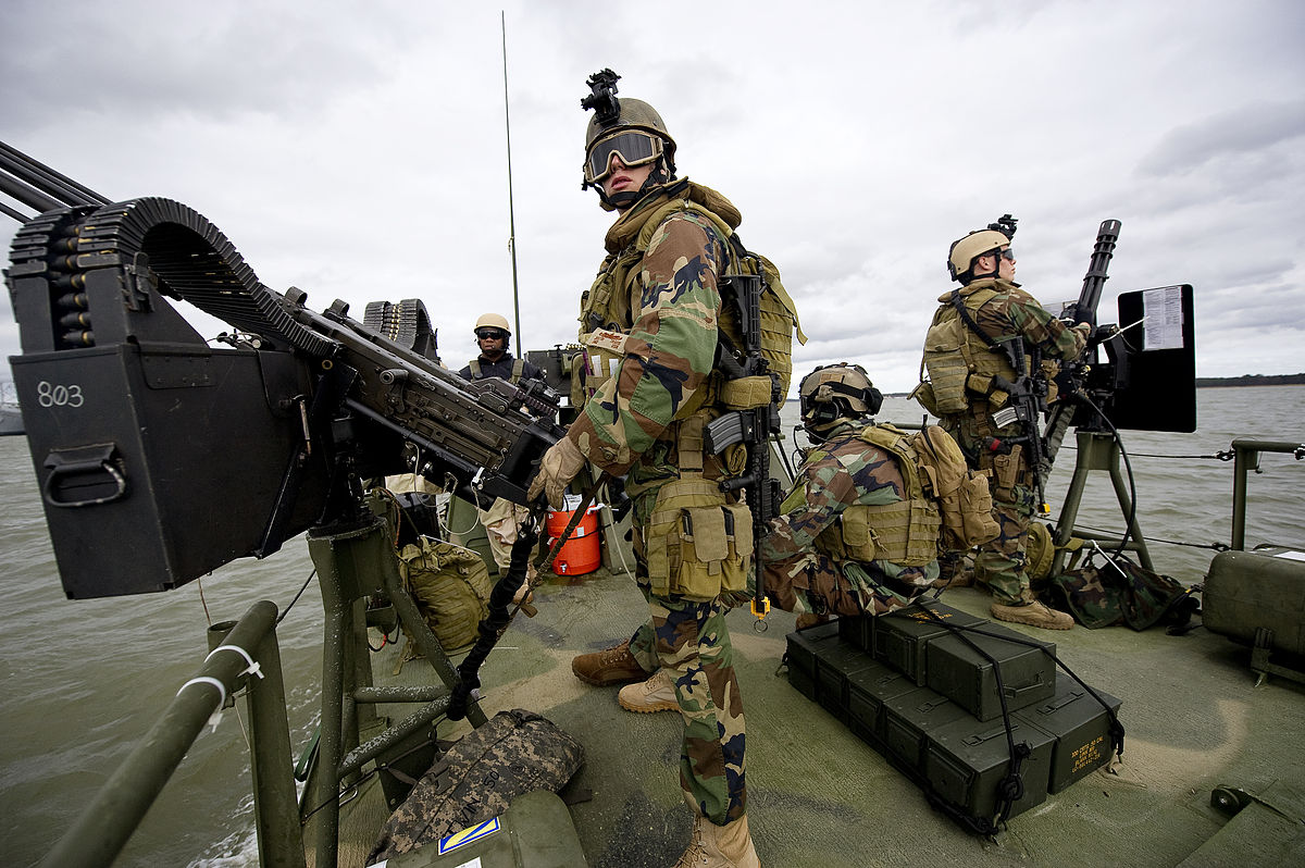 1200px-US_Navy_111207-N-PC102-050_Sailors_aboard_Riverine_Command_Boat_803%2C_assigned_to_Riverine_Squadron_%28RIVRON%29_1%2C_man_their_positions_as_gunners_while.jpg