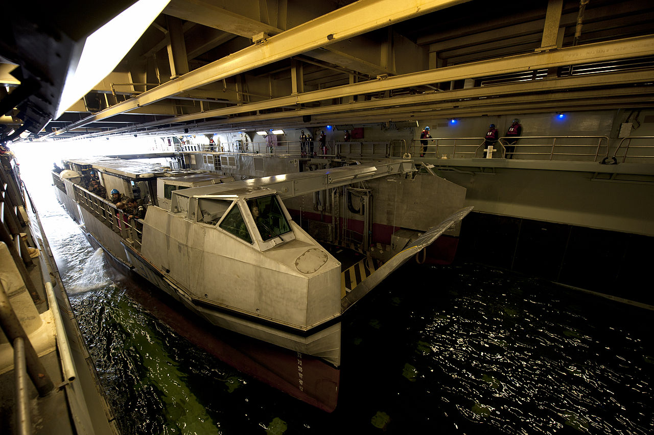 1280px-Flickr_-_Official_U.S._Navy_Imagery_-_A_French_landing_catamaran_%28L-CAT%29_pulls_into_the_well_deck_of_USS_Wasp..jpg