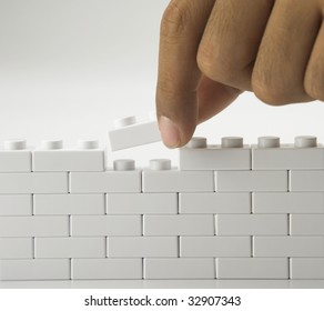 man-building-wall-by-stacking-260nw-32907343.jpg